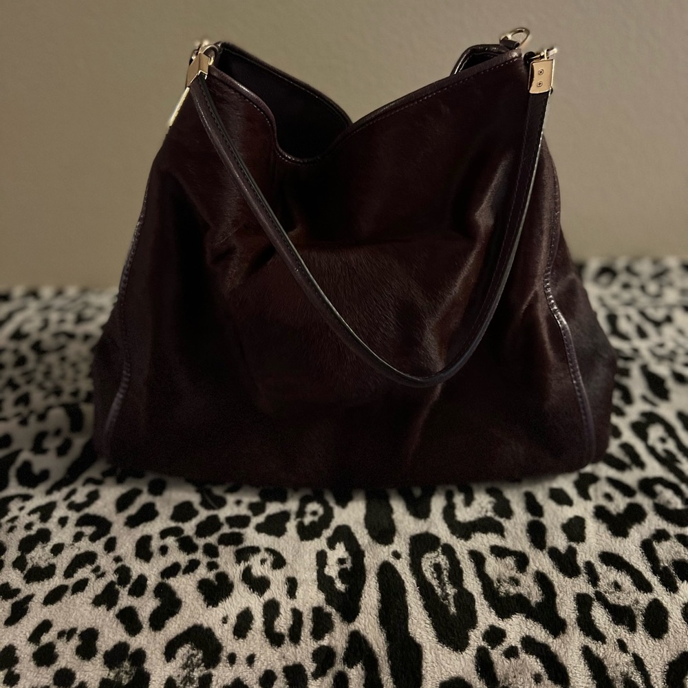This is a stunning plumb colored faux fur satchel from Coach.